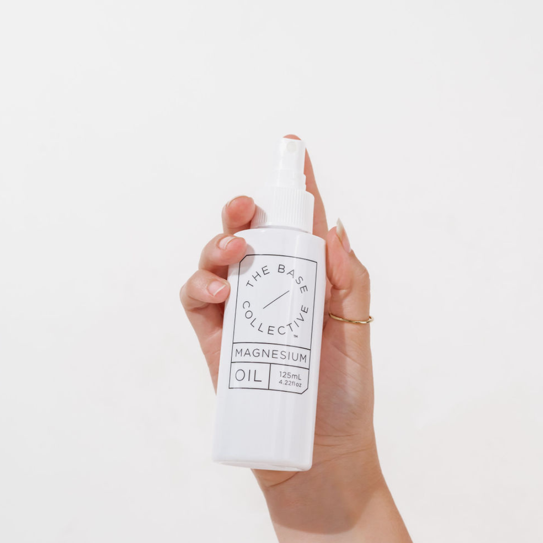 holding the bottle of magnesium oil