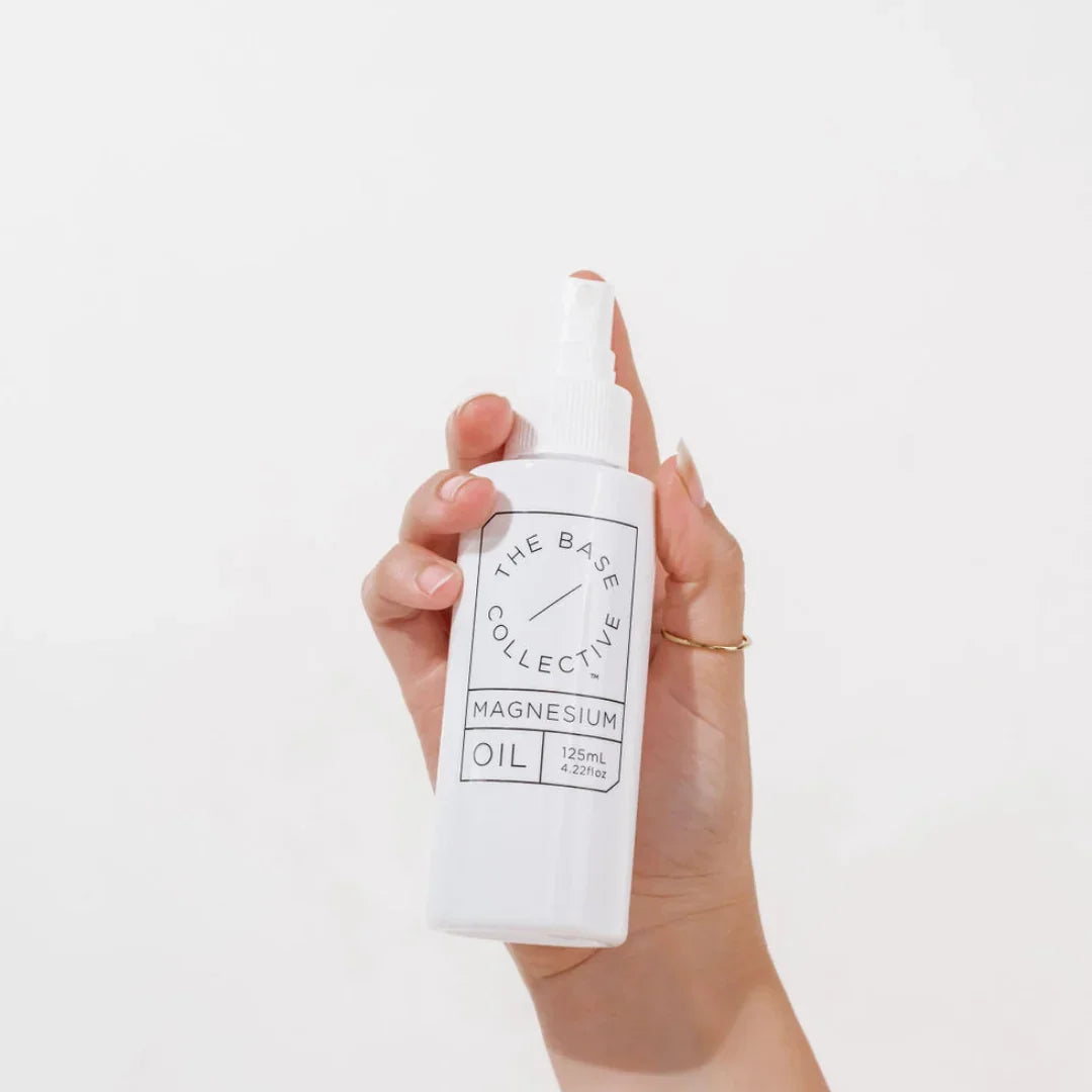 holding the bottle of magnesium oil