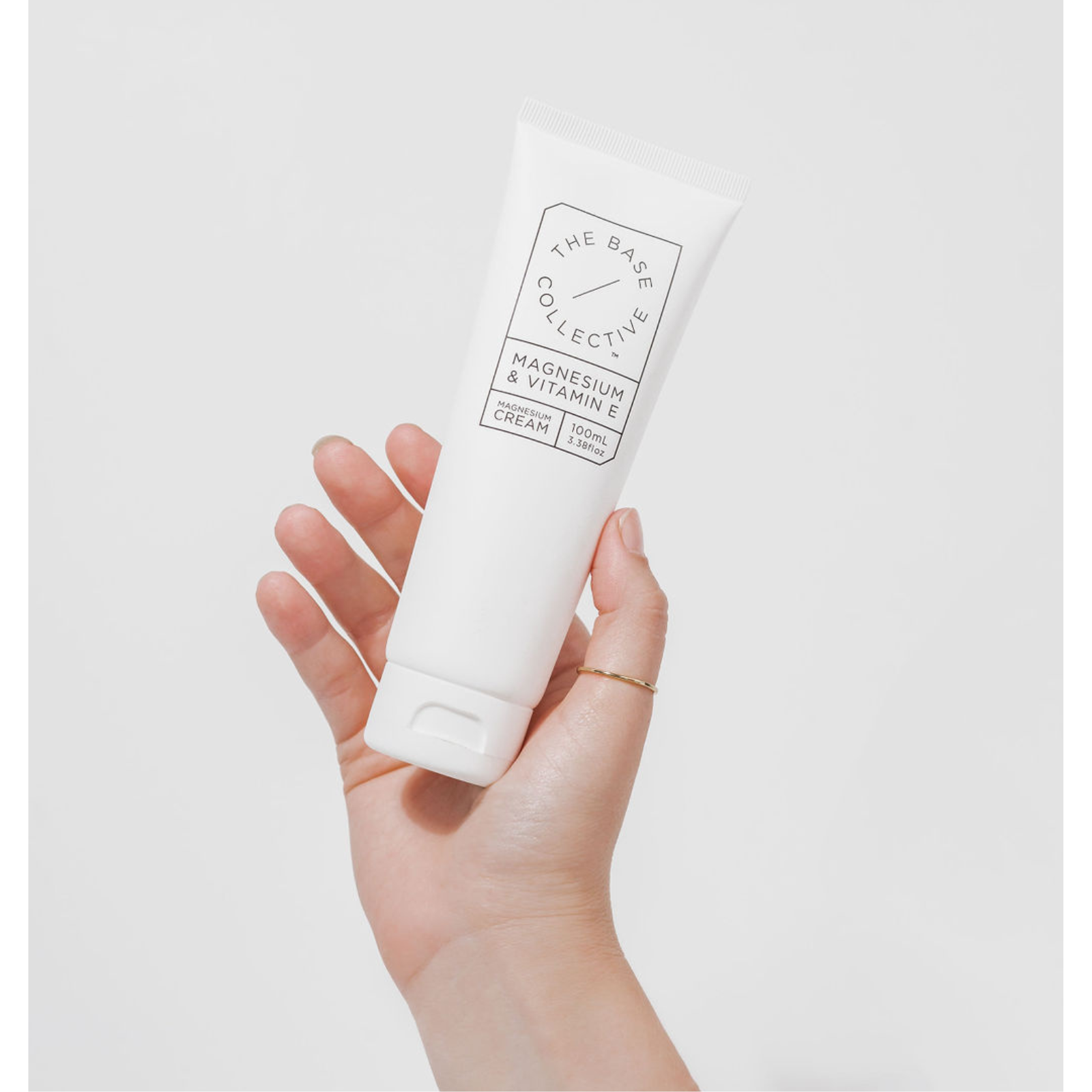 holding cream bottle in hand