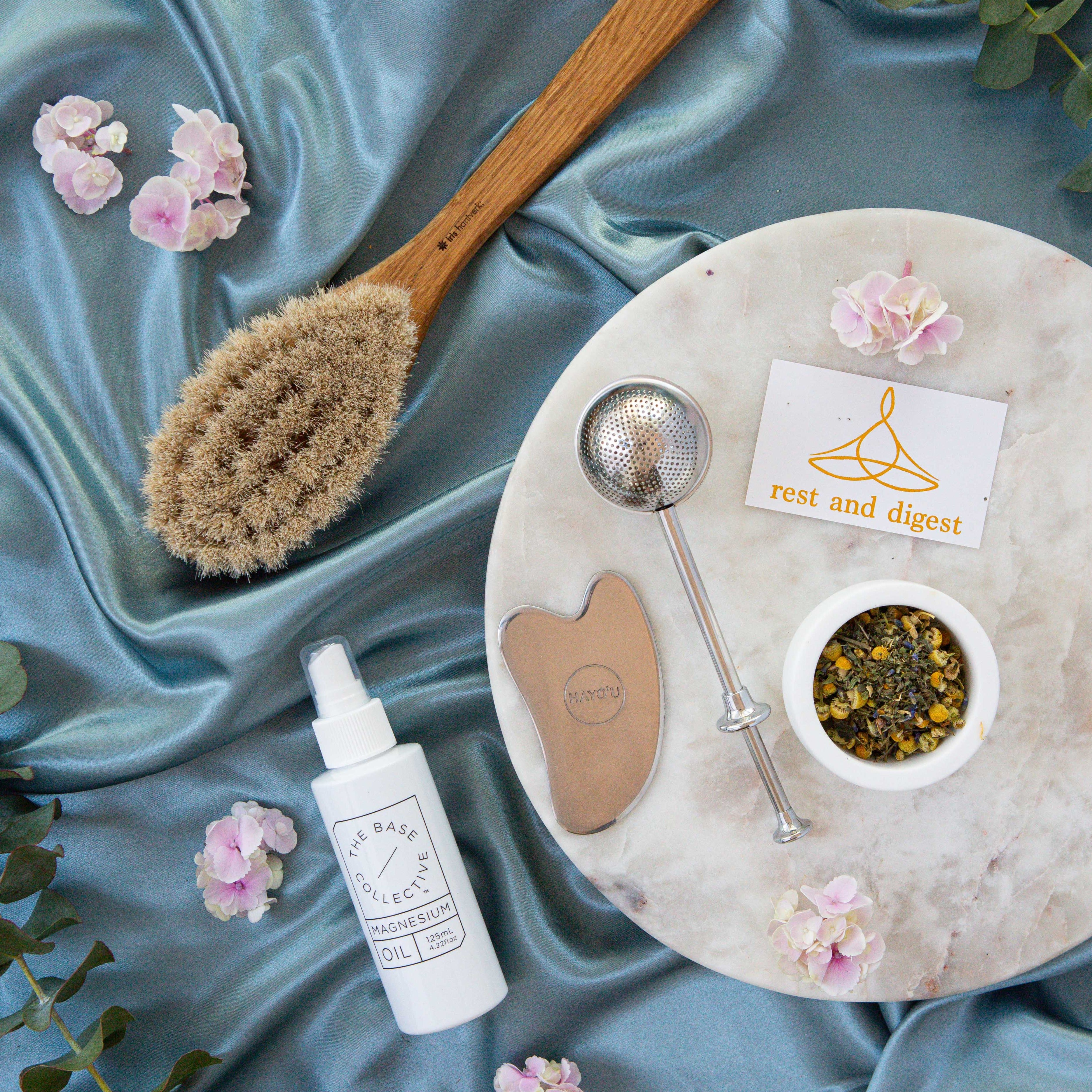 self care tools including body gua sha and magnesium oil spray